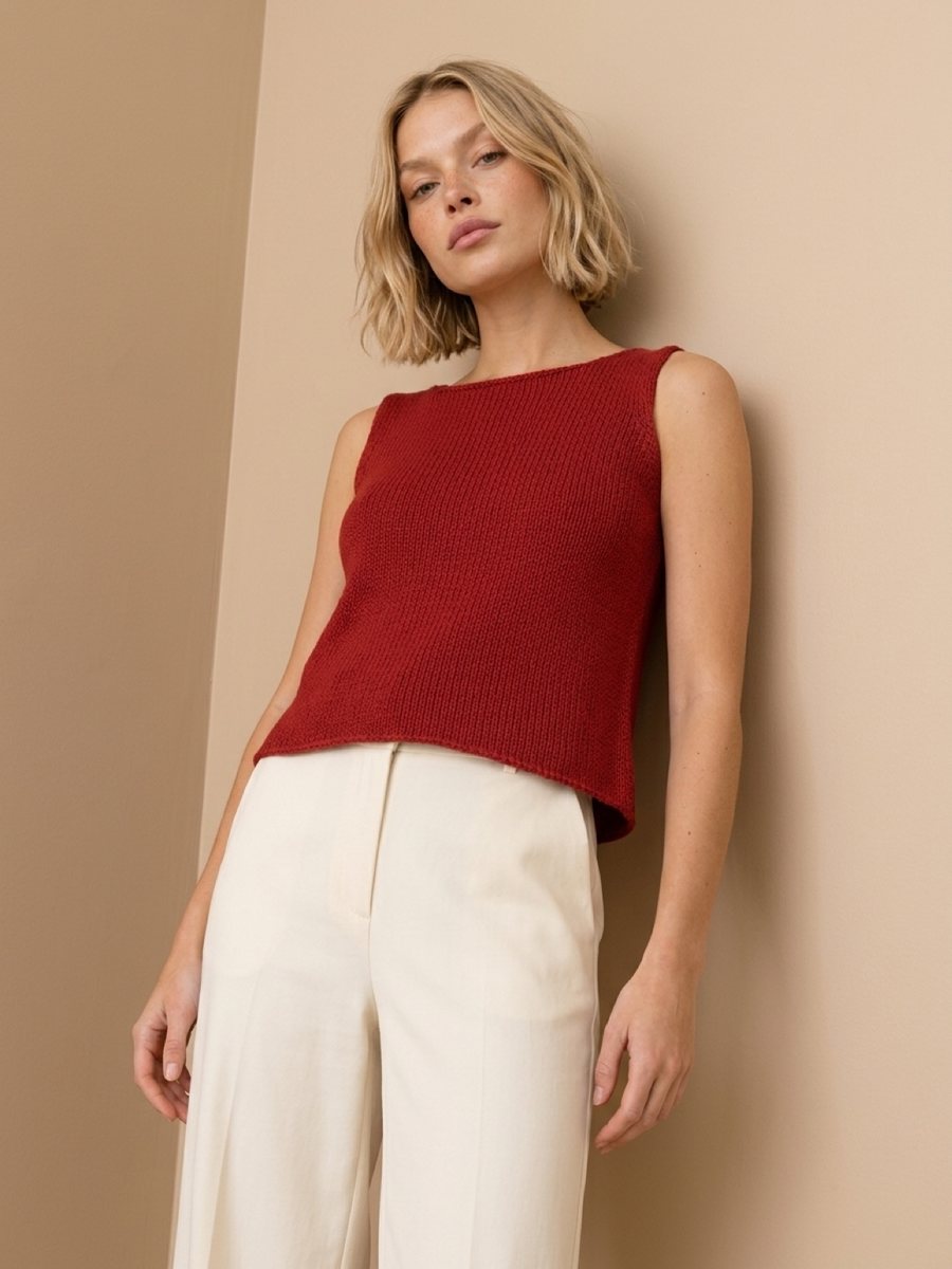 A burgundy knit top with cream trousers